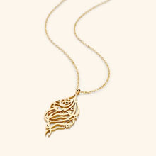 A beautifully designed silver necklace featuring Arabic calligraphy of the verse 