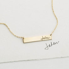 A Custom Handwriting Silver Necklace featuring a delicate engraving of handwriting on a sleek silver pendant with an elegant chain.

