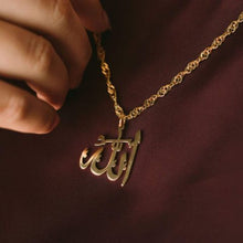 A bold silver necklace featuring Allah’s name in Arabic calligraphy, worn at a 16-inch length.

