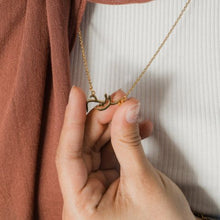 A sleek and elegant silver name necklace displayed on a model wearing it at 18 inches.

