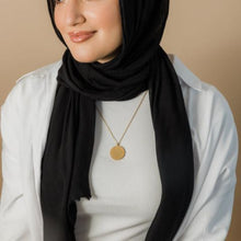 A stunning silver Ayatul Kursi necklace featuring Arabic calligraphy, worn at a 22-inch length.

