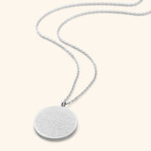 A stunning silver Ayatul Kursi necklace featuring Arabic calligraphy, worn at a 22-inch length.

