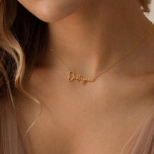 A sleek Miniature Silver Name Necklace featuring a contemporary personalized font and an adjustable chain.

