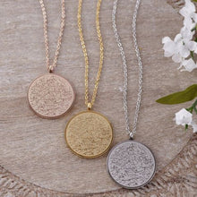 A stunning silver Ayatul Kursi necklace featuring Arabic calligraphy, worn at a 22-inch length.

