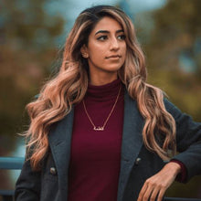 A sleek and elegant silver name necklace displayed on a model wearing it at 18 inches.

