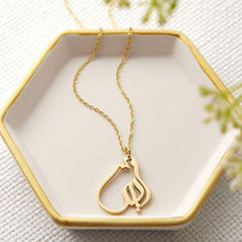 A silver necklace featuring a ready-made popular name in elegant Arabic calligraphy, crafted with artistic precision.

