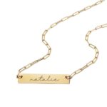 A personalized horizontal bar necklace in 18k gold-plated sterling silver, engraved with the name 'Amelia', on a delicate chain.
