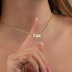 Gothic name necklace with the name 'Lilith' in Old English script, made from 18k rose gold-plated sterling silver on a curb chain.