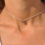 Floating initial 'K' necklace in 18k gold-plated sterling silver, showing the unique sideways letter integrated into the delicate chain.