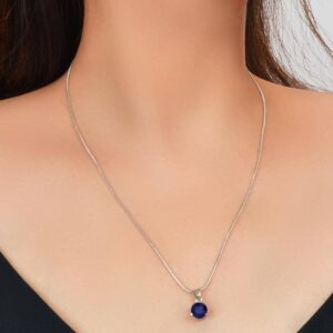 The Royal Sapphire Halo Jewelry Set in sterling silver, showing the matching necklace and earrings with their deep blue central stones and surrounding crystal halos.