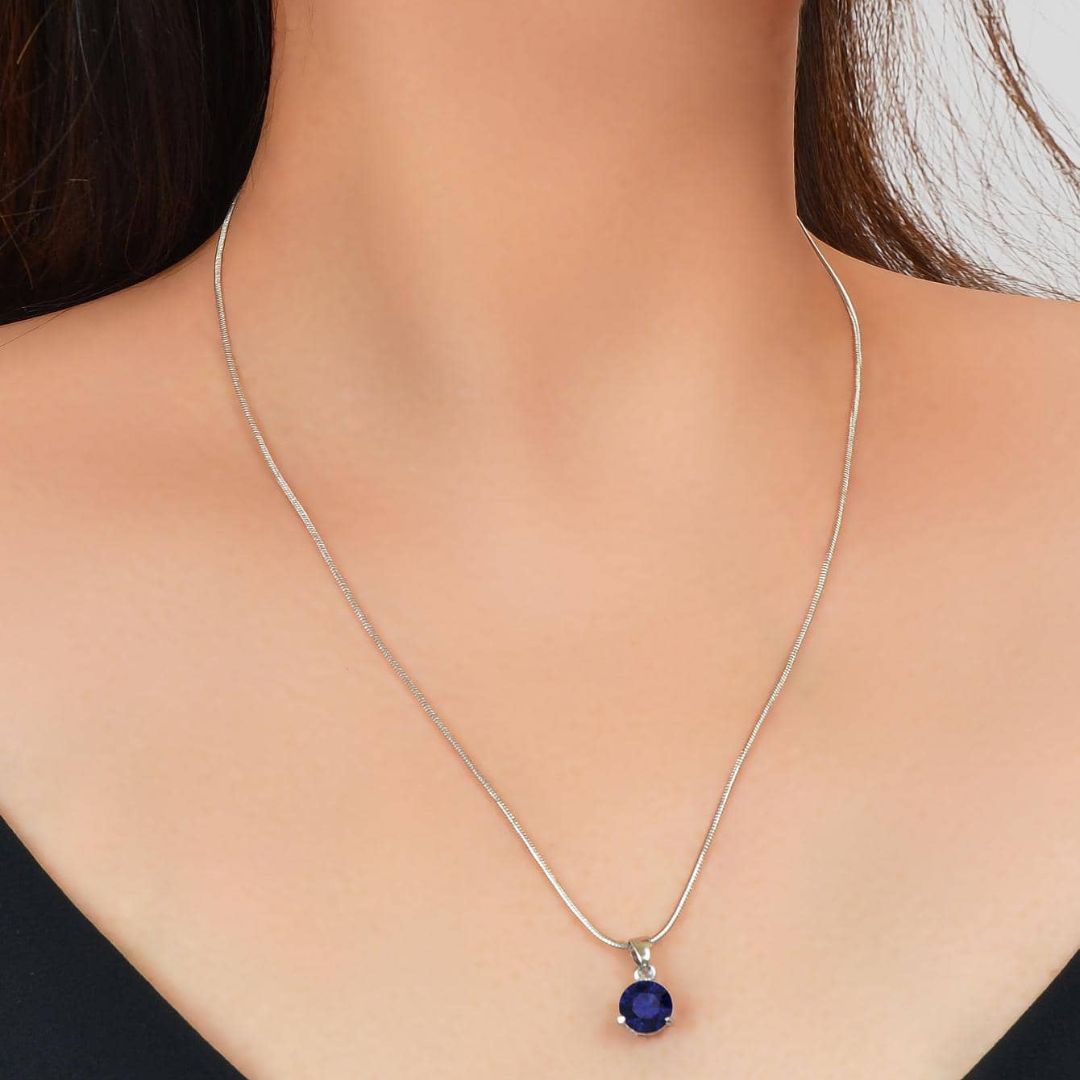 The Royal Sapphire Halo Jewelry Set in sterling silver, showing the matching necklace and earrings with their deep blue central stones and surrounding crystal halos.