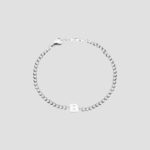 A bold initial 'B' curb chain bracelet in 18k gold-plated sterling silver, worn on a wrist to show its style and substantial fit.