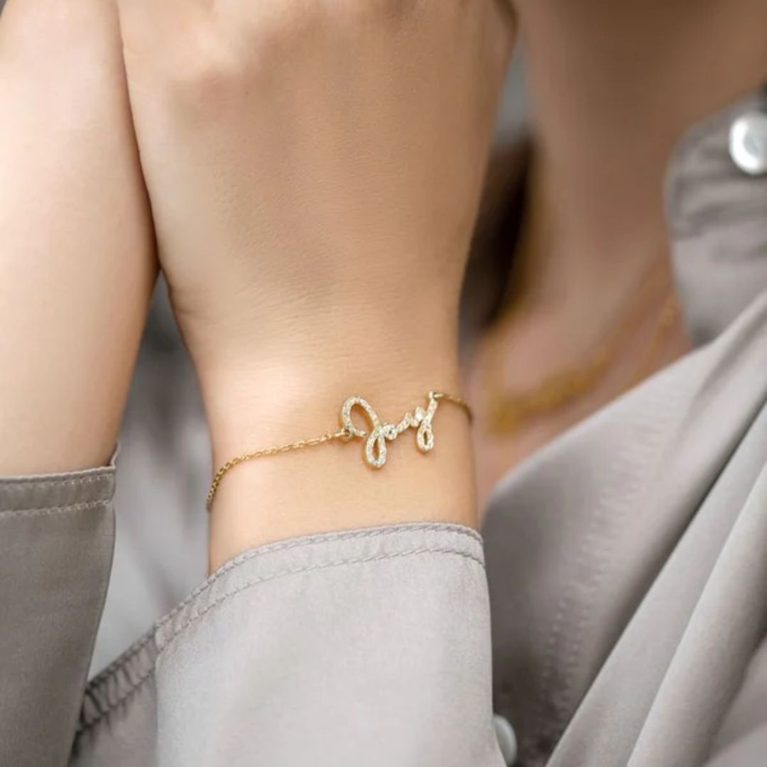 Radiant Diamond-Cut Bangle in 18k gold-plated sterling silver, worn on a woman's wrist and showcasing the light-catching textured surface.