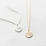 Unbreakable Bond Pinky Promise necklace in 18k gold-plated sterling silver, showing the detailed pendant of two hands clasped.