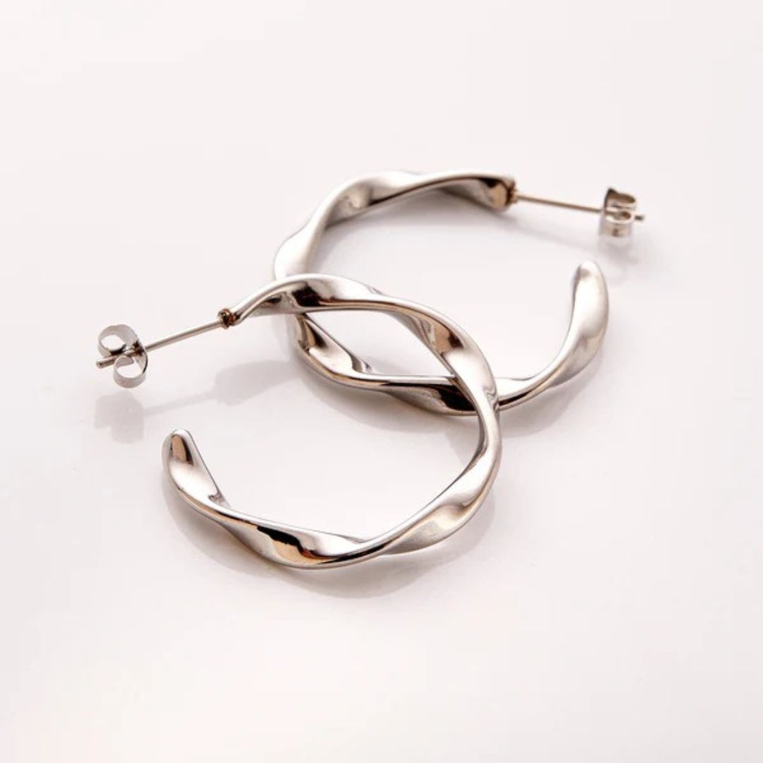 A pair of Liquid Ripple Hoop Earrings in 18k gold-plated sterling silver, showcasing their unique textured, light-catching surface.