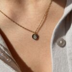 Personalized Evil Eye and Initial 'A' charm necklace in 18k gold-plated sterling silver, showing both charms on a delicate chain.