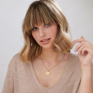 Minimalist hexagon necklace in 18k gold-plated sterling silver, showing the polished geometric pendant on a delicate chain.