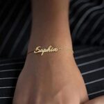 Dainty 'Sophia' name bracelet in 18k gold-plated sterling silver, worn on a woman's wrist.