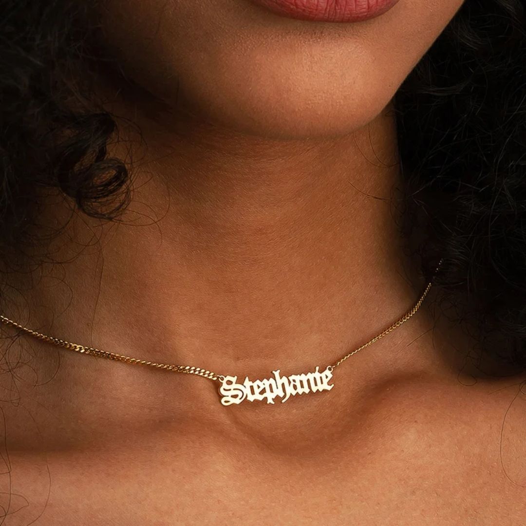 Gothic name necklace with the name 'Lilith' in Old English script, made from 18k rose gold-plated sterling silver on a curb chain.