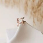 Personalized two-name ring in 18k rose gold-plated sterling silver, showing the names 'Noah' and 'Emma' on the open band design.