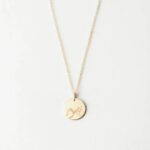 Unbreakable Bond Pinky Promise necklace in 18k gold-plated sterling silver, showing the detailed pendant of two hands clasped.