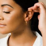 A pair of Liquid Ripple Hoop Earrings in 18k gold-plated sterling silver, showcasing their unique textured, light-catching surface.