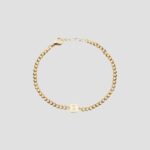 A bold initial 'B' curb chain bracelet in 18k gold-plated sterling silver, worn on a wrist to show its style and substantial fit.
