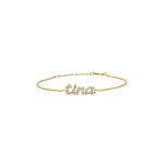 Dainty 'Madison' name bracelet in 18k gold-plated sterling silver, fully 'iced out' with sparkling crystals, on a woman's wrist.