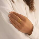 Personalized two-name ring in 18k rose gold-plated sterling silver, showing the names 'Noah' and 'Emma' on the open band design.