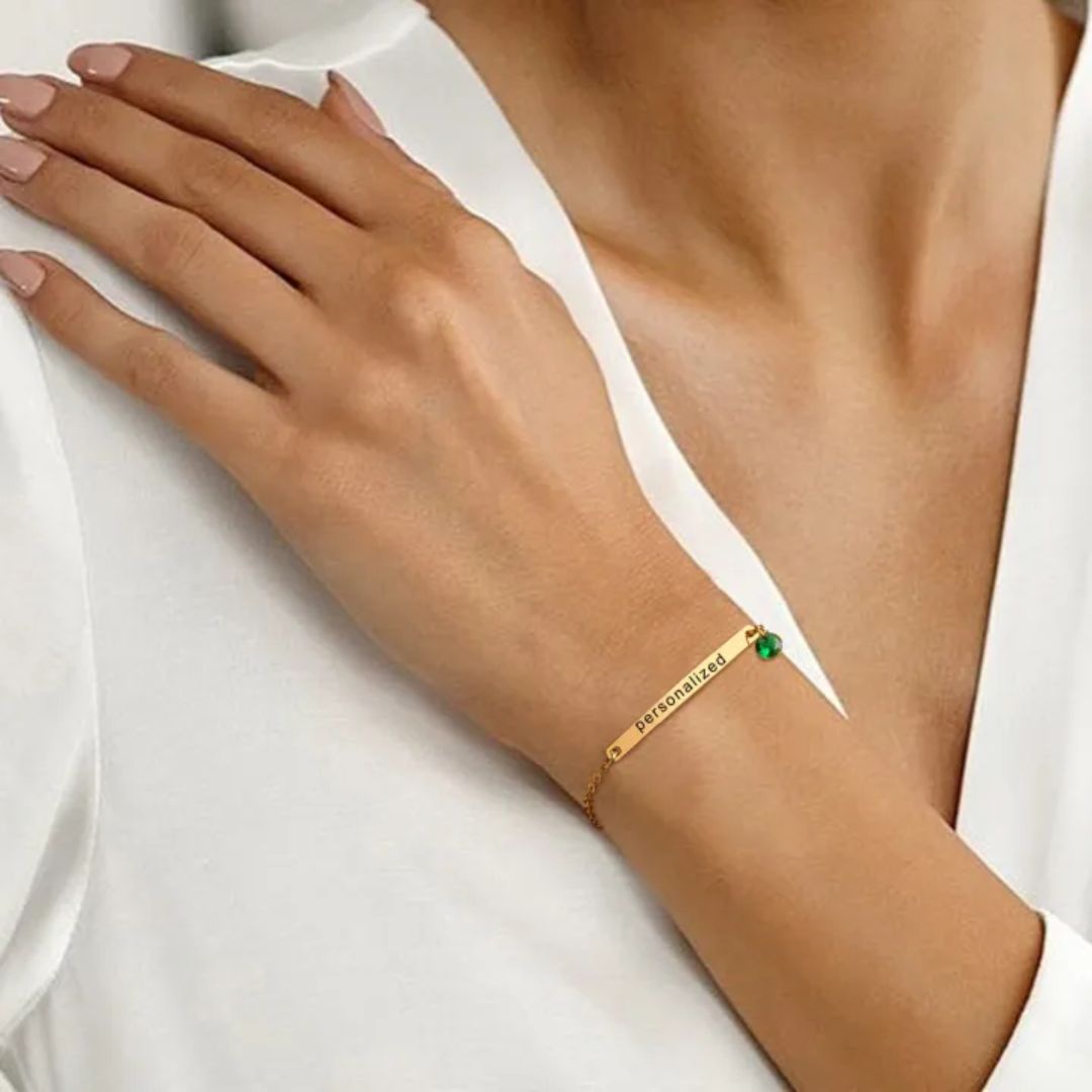 A personalized 'Chloe' bar bracelet in 18k gold-plated sterling silver, showing the engraved name and sparkling crystal accent.