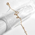 Radiant Diamond-Cut Bangle in 18k gold-plated sterling silver, worn on a woman's wrist and showcasing the light-catching textured surface.