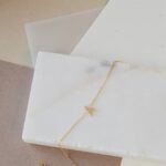 Dazzling pave initial 'A' bracelet in 18k gold-plated sterling silver, sparkling on a woman's wrist.