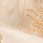 Dazzling pave initial 'M' necklace in 18k gold-plated sterling silver, sparkling on a delicate chain.