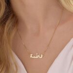 Personalized 'Amanda' name necklace in 18k gold-plated sterling silver, hanging from a delicate chain on a neutral background.