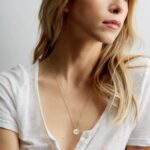 Unbreakable Bond Pinky Promise necklace in 18k gold-plated sterling silver, showing the detailed pendant of two hands clasped.
