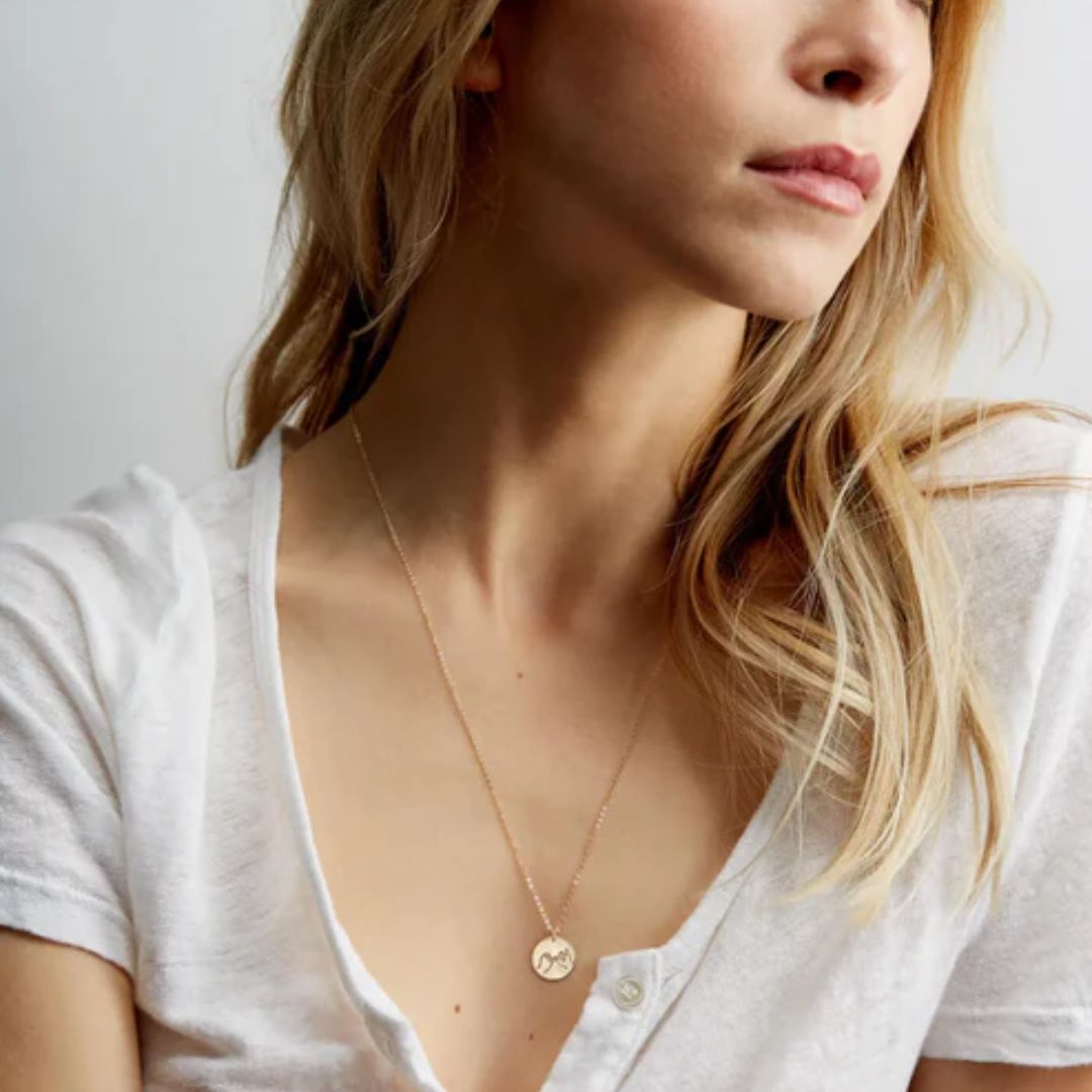 Unbreakable Bond Pinky Promise necklace in 18k gold-plated sterling silver, showing the detailed pendant of two hands clasped.
