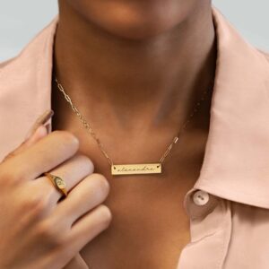 A personalized horizontal bar necklace in 18k gold-plated sterling silver, engraved with the name 'Amelia', on a delicate chain.