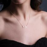 Personalized 'Olivia' name necklace in 18k rose gold-plated sterling silver, hanging from a delicate chain on a neutral background.