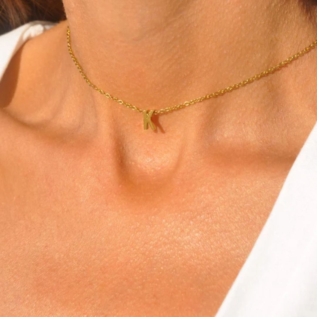 Floating initial 'K' necklace in 18k gold-plated sterling silver, showing the unique sideways letter integrated into the delicate chain.