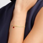 A personalized 'Chloe' bar bracelet in 18k gold-plated sterling silver, showing the engraved name and sparkling crystal accent.