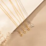 Dazzling pave initial 'M' necklace in 18k gold-plated sterling silver, sparkling on a delicate chain.