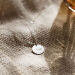 Unbreakable Bond Pinky Promise necklace in 18k gold-plated sterling silver, showing the detailed pendant of two hands clasped.