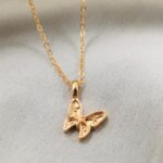Graceful butterfly pendant necklace in 18k gold-plated sterling silver, showing the delicate charm on a fine chain.