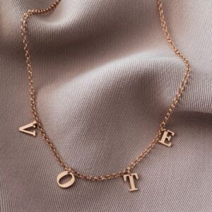 Dangling Family Initials Necklace in 18k gold-plated sterling silver, showing multiple letter charms (e.g., A, S, M) hanging from a delicate chain.