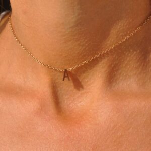 Floating initial 'K' necklace in 18k gold-plated sterling silver, showing the unique sideways letter integrated into the delicate chain.