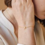 Dazzling pave initial 'A' bracelet in 18k gold-plated sterling silver, sparkling on a woman's wrist.