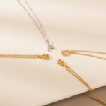 Dazzling pave initial 'M' necklace in 18k gold-plated sterling silver, sparkling on a delicate chain.