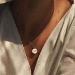 Unbreakable Bond Pinky Promise necklace in 18k gold-plated sterling silver, showing the detailed pendant of two hands clasped.