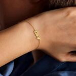 Dainty 'Sophia' name bracelet in 18k gold-plated sterling silver, worn on a woman's wrist.