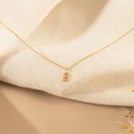 Dazzling pave initial 'M' necklace in 18k gold-plated sterling silver, sparkling on a delicate chain.